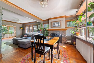 Dining room with ornamental molding, hardwood floo