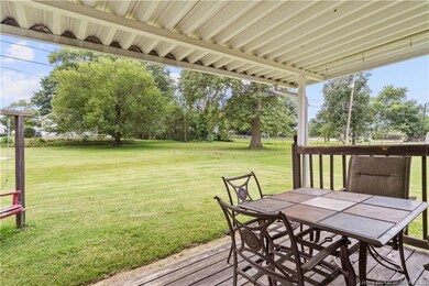 Covered deck over looks the large back yard.