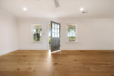Foyer entrance with crown molding, light wood-style floors, a ceiling fan, and recessed lighting