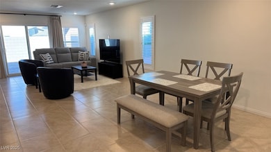 Dining space featuring light tile patterned floors and recessed lighting