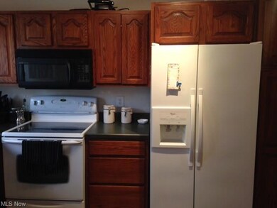 Kitchen includes all appliances and sturdy oak cabinetry and pantry area.