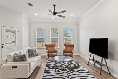 Living room with crown moulding and beautiful row of windows