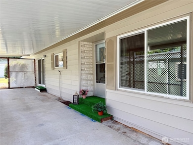 Covered front patio, large enough for entertaining.