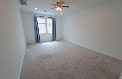 Empty room featuring ceiling fan, light carpet, b