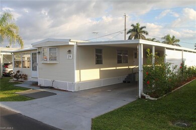 View of property exterior with a carport and a law
