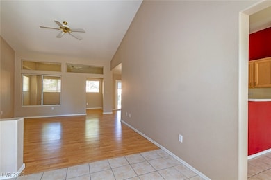 Spare room with a ceiling fan, light tile patterne