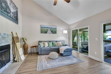 Living room featuring ceiling fan, a fireplace, hi