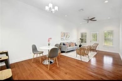 Living room featuring baseboards, ceiling fan wit