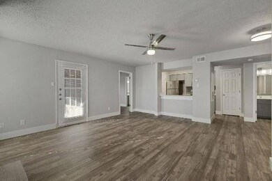 Unfurnished living room featuring a textured ceili