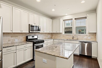 Kitchen featuring a sink, dark wood-style floorin