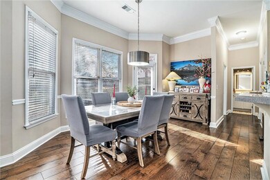 Dining space featuring ornamental molding and dark