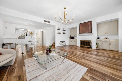 Living area featuring stairway, a chandelier, lig