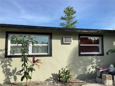 View of property exterior with stucco and a wall unit AC
