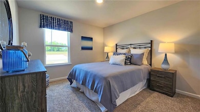 Carpeted bedroom with baseboards
