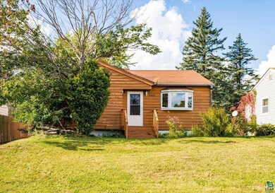 Back of property featuring a lawn
