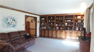 Large living room has 2 oversized windows and buil