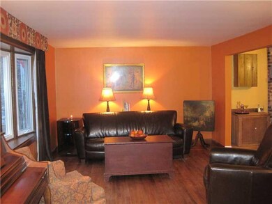 Living Room. Exposed hardwood floors; bowed window
