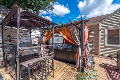 Wooden deck featuring hot tub and a gazebo