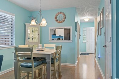 Dining space featuring light wood-style flooring and a textured ceiling