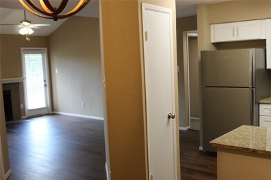 Another view to the Living Room and kitchen shown from the dining area. It also shows the door leading to your balcony.