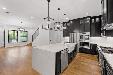 Kitchen featuring visible vents, a sink, a chande