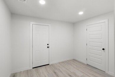 Spare room featuring light wood-type flooring