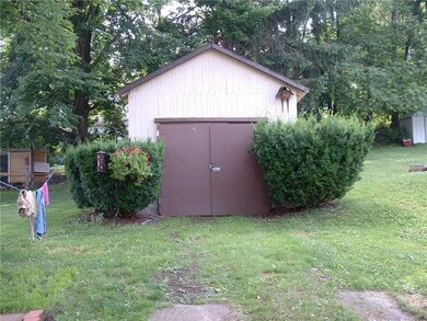 Exterior Back. Single car garage Property line goe