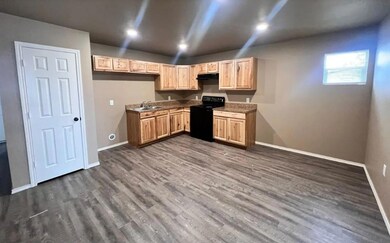 Kitchen featuring black electric range oven, a sin