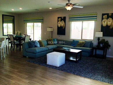 Den. Photo is of 1630 plan model home. Property fo