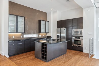 The impressive kitchen boasts a sleek tile accent