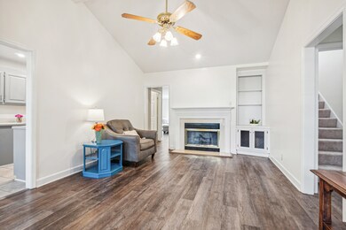 Cozy Fireplace in the Family Room ~ Look at the gorgeous LVP floors & custom built-ins!