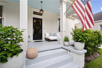 View of exterior entry with covered porch