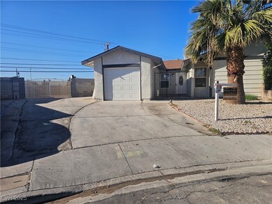 View of front of property featuring driveway, a ga