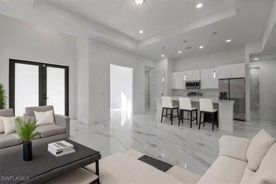 Living room with a raised ceiling and french doors