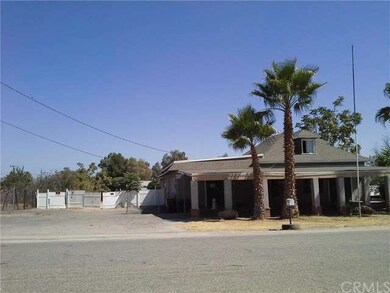 FRONT OF HOME WITH PARKING AREA AND COVERED CARPOR