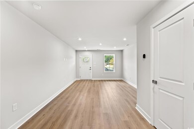 Entrance foyer with recessed lighting and light wood-type flooring