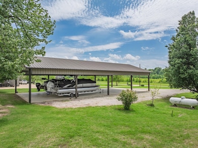 View of parking / parking lot featuring a carport