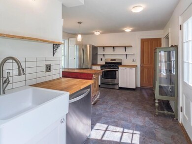 The kitchen has a slate floor, a...