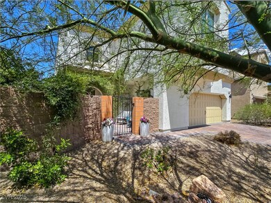 View of side of home with stucco siding, a gate, a