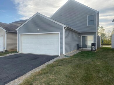Rear of home with 2 car garage