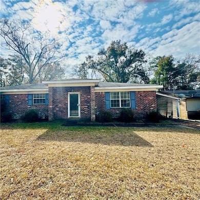 Single story home with a front lawn