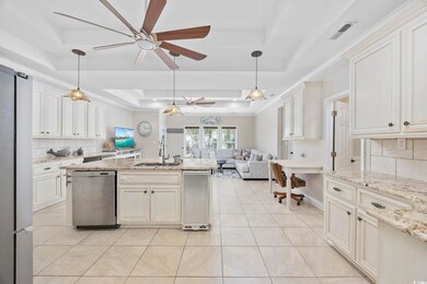 Kitchen featuring a tray ceiling, stainless steel 