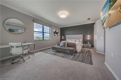 Bedroom featuring ornamental molding and carpet fl