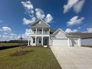 View of front of home featuring a garage, covered 