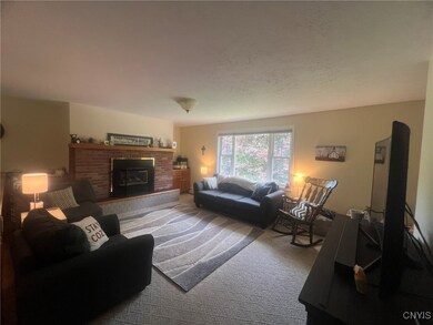 Living room with gas fireplace and large window fo