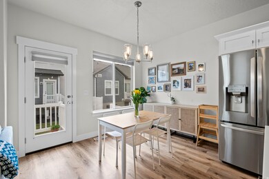 Dining room featuring light wood finished floors and a chandelier