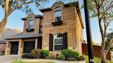 View of front of property with roof with shingles, fence, brick siding, an attached garage, and driveway