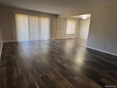 Unfurnished room featuring dark wood-style floors