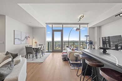 Living room featuring floor to ceiling windows an