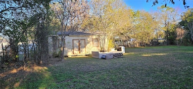 View of grassy yard with an outbuilding